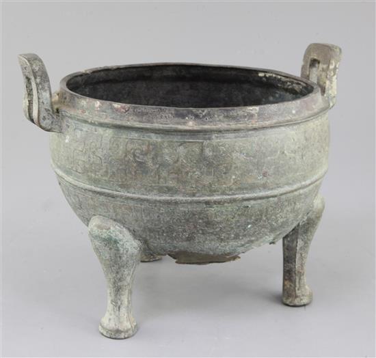 A Chinese archaic bronze tripod ritual food vessel, Ding, Eastern Zhou dynasty, 26.5cm wide, holes to base, cover lacking